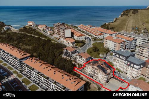 an aerial view of a city with a red arrow at Hotel Flysch in Zumaia