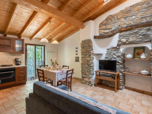 a kitchen and living room with a stone wall at Holiday Home Ca' da Ciassa - Prima Porta - VLO132 by Interhome in Pantasina
