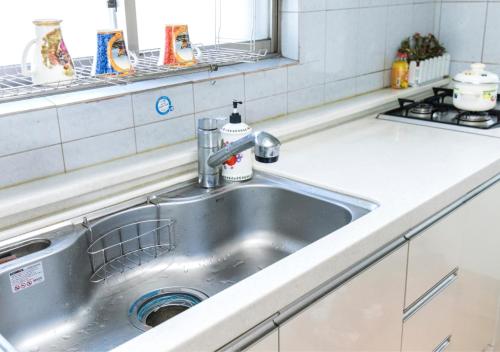 a stainless steel sink in a kitchen at Homestay Eve in Seoul