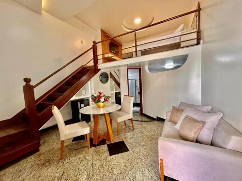 a living room with a couch and a table at Hotel Riviera D Amazonia Belem Ananindeua in Belém