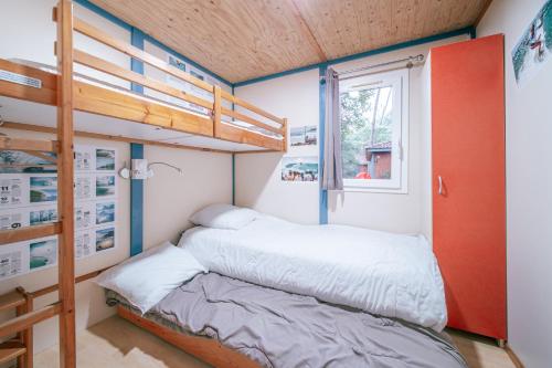a bedroom with a bunk bed and a window at Camping LANDAE in Ondres