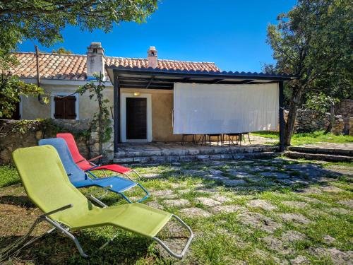 a group of chairs in front of a house at Holiday Home Tomiceva by Interhome in Gornja Klada