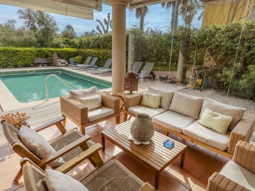 a patio with furniture and a swimming pool at Villa Bertoni Golf & Sea by Interhome in Reus