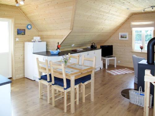 a kitchen with a table and chairs in a room at Apartment Vardeheii by Interhome in Arnefjord