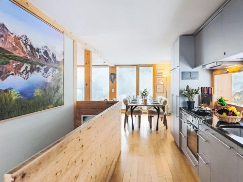 a kitchen with a table and a dining room at Apartment Roossi Apt- 1 by Interhome in Wengen