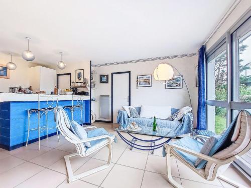 a living room with a table and two chairs at Holiday Home TY Greg by Interhome in Crozon