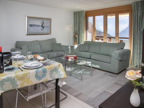 a living room with a couch and a table at Apartment Bella Vista Apt- No- 09 by Interhome in Wengen