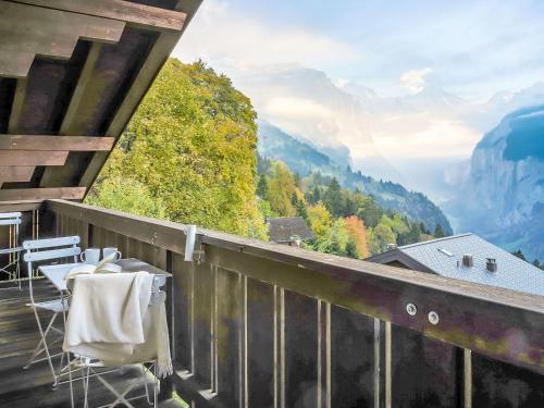 a balcony with chairs and a view of mountains at Apartment Plein Soleil by Interhome in Wengen