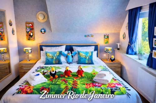 a bedroom with a bed with three rubber ducks on it at Hotel Wappenhof in Braunlage