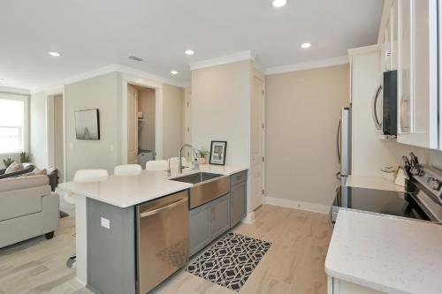 a kitchen with a sink and a refrigerator at Just Beach Baby! by Pristine Property Vacation Rentals in Cape San Blas