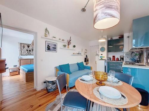 a living room with a table and a blue couch at Apartment la Pergola-2 by Interhome in Soorts-Hossegor