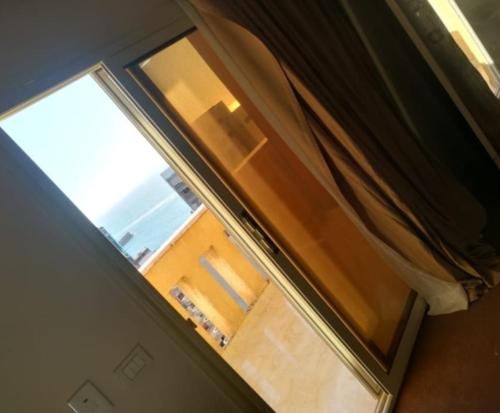 an open window with a view of a room at Ibiza beach apartments in Alexandria