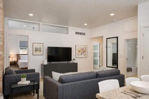 a living room with a couch and a tv at Luxury Downtown 2 Bedroom Flat in Neenah