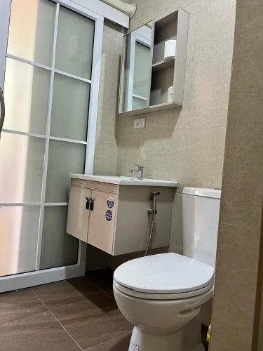 a bathroom with a toilet and a sink at Sukhothai Indy Resort in Sukhothai