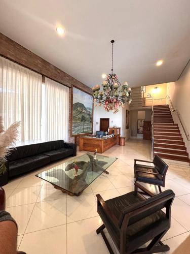 a living room with a couch and a chandelier at Rodoserv Hotel in Pardinho