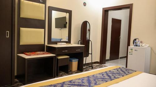 a bathroom with a sink and a mirror at Tamyoz Aqama for Serviced Apartments in Hail