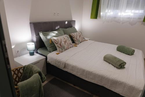 a bed with two pillows on it in a bedroom at Apartman Kelečić in Gornji Stupnik