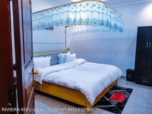 a bedroom with a bed with a canopy at Riviera Kivu View in Gisenyi