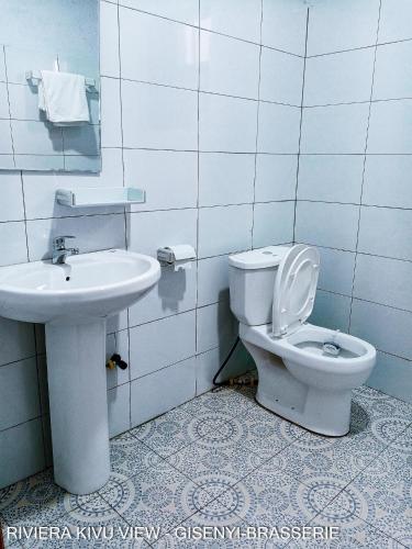 a bathroom with a toilet and a sink at Riviera Kivu View in Gisenyi