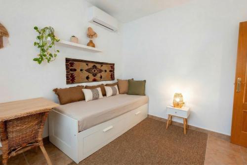a small bedroom with a bed and a table at Comeback Villa Itaca in Motril