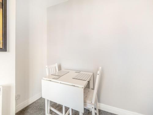 a desk in a room with a laptop on it at Buttercup Apartment - Uk42382 in Bridlington