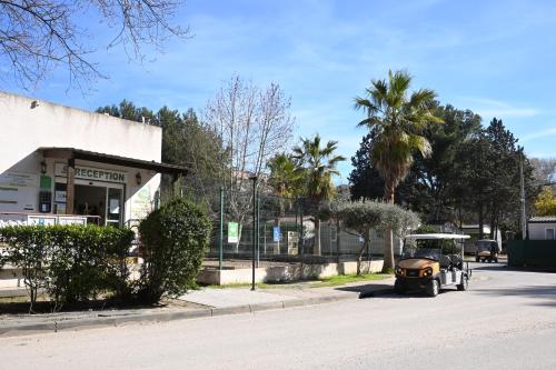 an old car parked in front of a building at Camping Marina Plage in Vitrolles