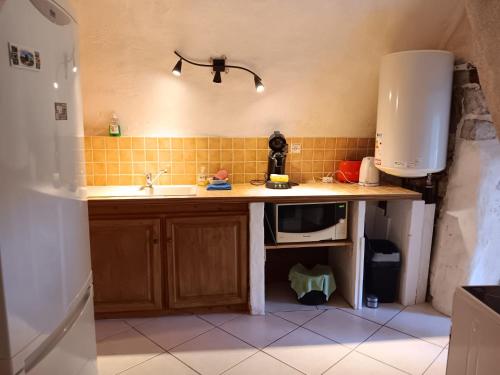 a kitchen with a sink and a counter top at Maison ardéchoise atypique in Chomérac