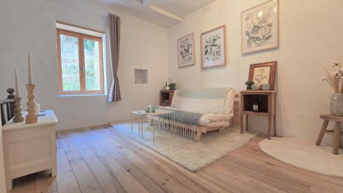 a living room with a chair and a table at L'Hirondelle in Airvault