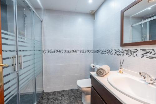 a bathroom with a toilet and a sink and a shower at Euma Apartment in Cunit