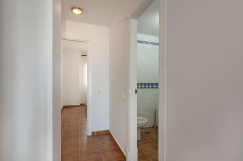 a corridor of a bathroom with a toilet at Marina IV by Ĥ - Marina Isla Canela PMHIV25P25 in Isla del Moral