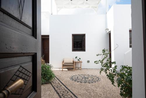 an open door to a room with a chair at Elegant-Lindian Villa Marietta in Lindos