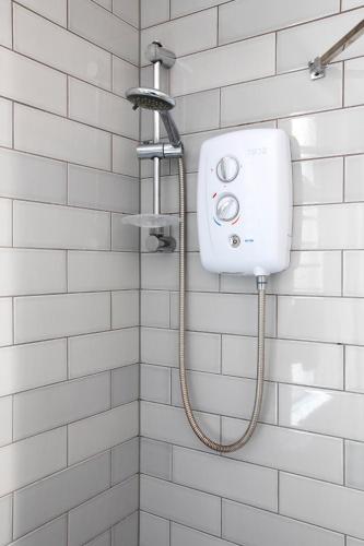 a shower with a soap dispenser on a wall at CITY HEART BRIGHTON in Brighton & Hove