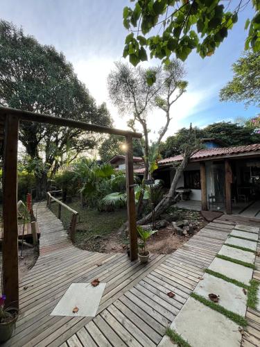 a wooden deck in front of a house at Mato Verde Hospedaria - À beira da Lagoa - Praia do Rosa in Imbituba