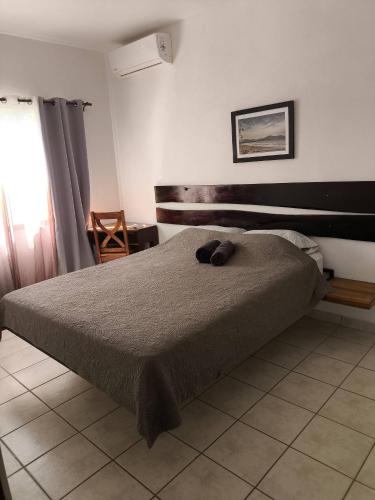 a bedroom with a bed with a wooden headboard at Marina Loft unit 2 floor, 201 in Coco