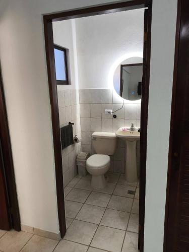 a bathroom with a toilet and a sink at Marina Loft unit 2 floor, 201 in Coco
