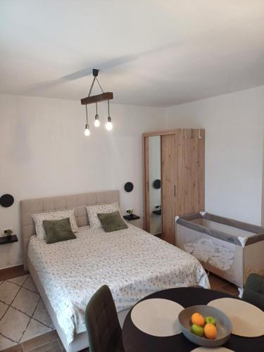 a bedroom with a bed and a bowl of fruit on a table at Vinea Nature in Brkač