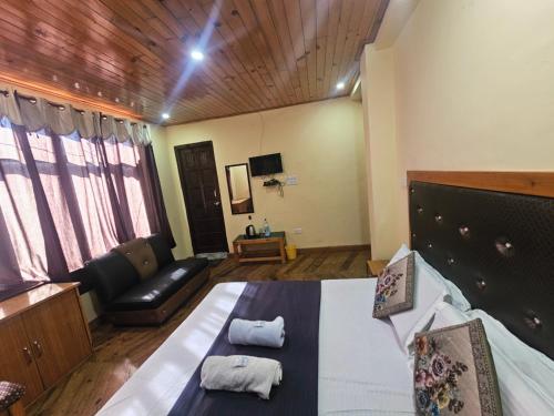 a large room with a bed and a couch at Smarthill Deodar Echoes in Dalhousie