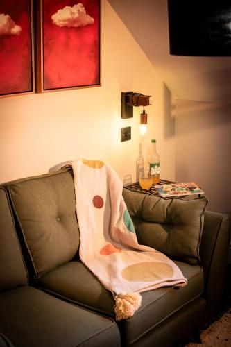 a blanket sitting on the back of a couch at Stay at Plattens in Wells next the Sea
