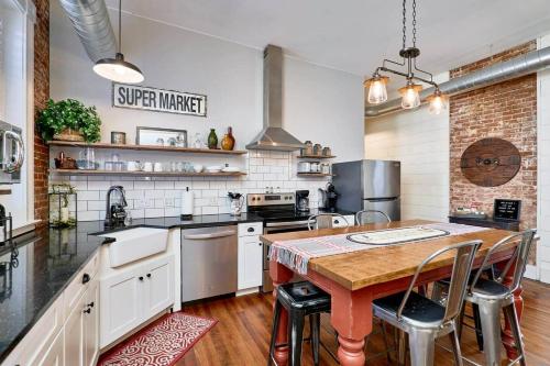 a large kitchen with a wooden table and appliances at Studio 1892 Guesthouse in Hermann