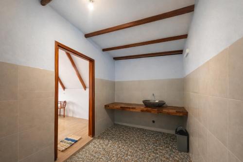 a bathroom with a sink and a mirror at Harmony Beachfront Bungalow in Gili Meno