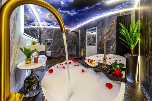 a bathroom with a white tub with roses on it at VALEA MAGURII in Novaci-Străini
