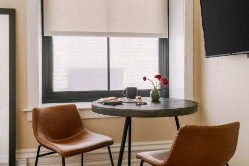 a table in a room with a window and two chairs at LIVN Millennium Park Downtown Chicago Studio in Chicago