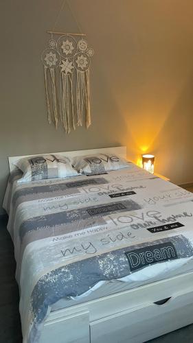 a bedroom with a bed with certificates on it at Villa turquoise - piscine privée, terrasse bois in Saint-Jean-de-Monts