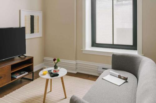 a living room with a chair and a tv at LIVN Millennium Park Downtown Chicago 1 BR in Chicago