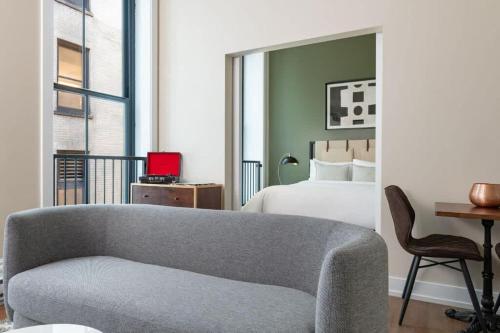 a living room with a couch and a bed at LIVN Millennium Park Downtown Chicago 1 BR in Chicago
