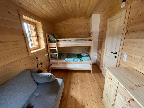 a room with two bunk beds in a wooden cabin at TANAs Almhütte in Flattnitz