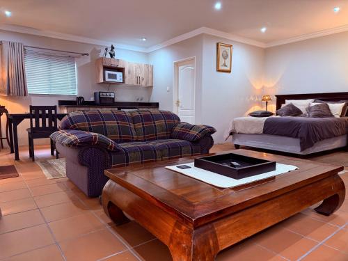 a living room with a bed and a coffee table at Pringle Studio in Benoni