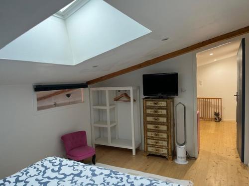 a bedroom with a bed and a flat screen tv at AN GOVEL in Crozon