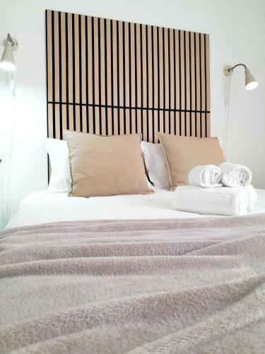 a bedroom with a large bed with white sheets and pillows at Easy4Stay in Portimão