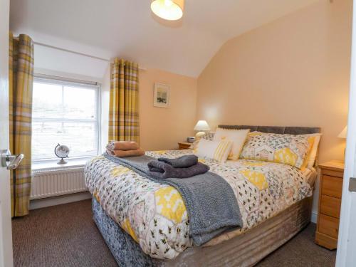 a bedroom with a bed and a window at Hill View in Bala
